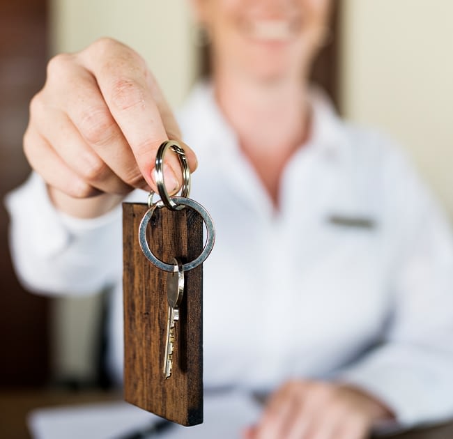 Hotel concierge handing a hotel key