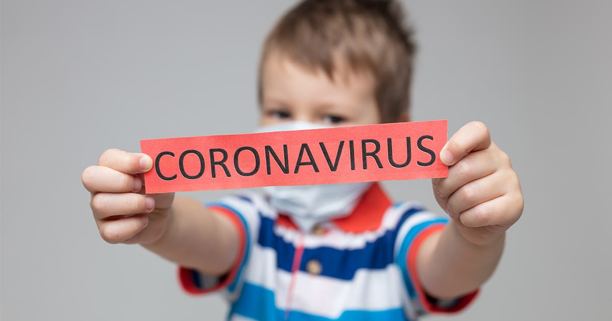 Young boy holding a coronavirus sign